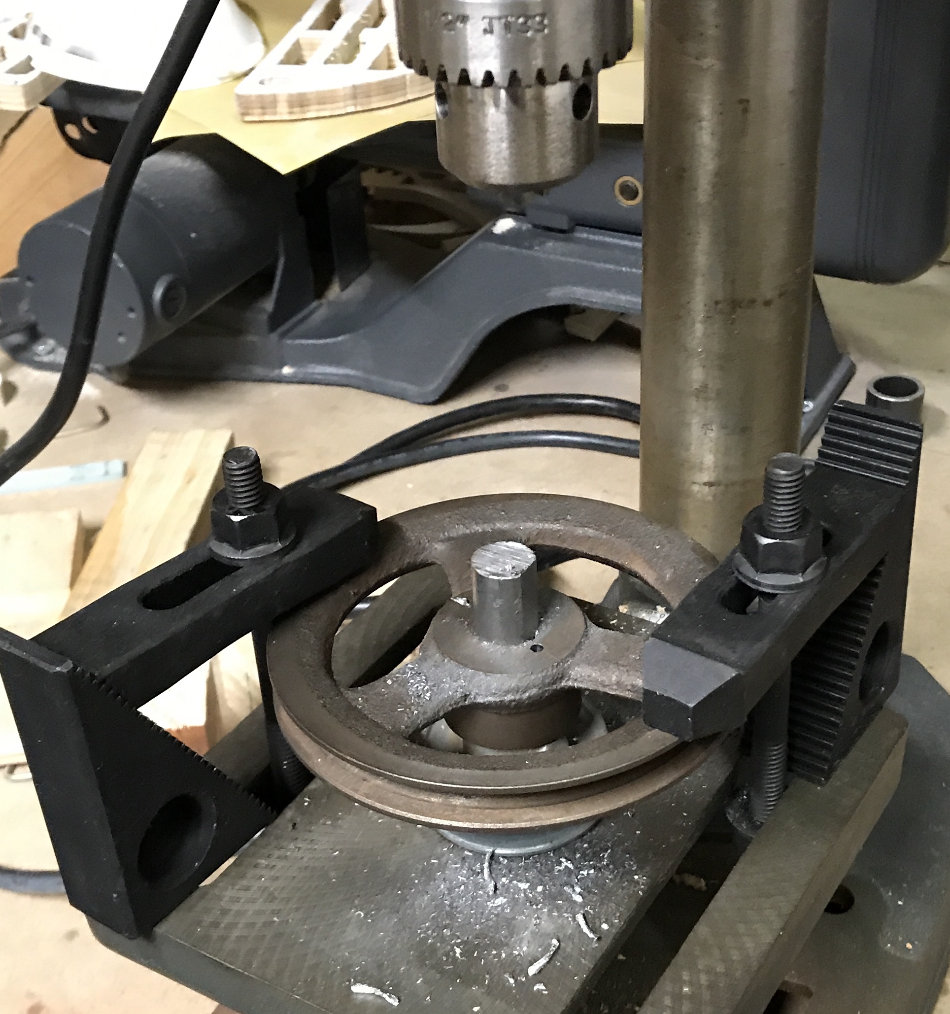 The two pulleys clamped to the table and drilled